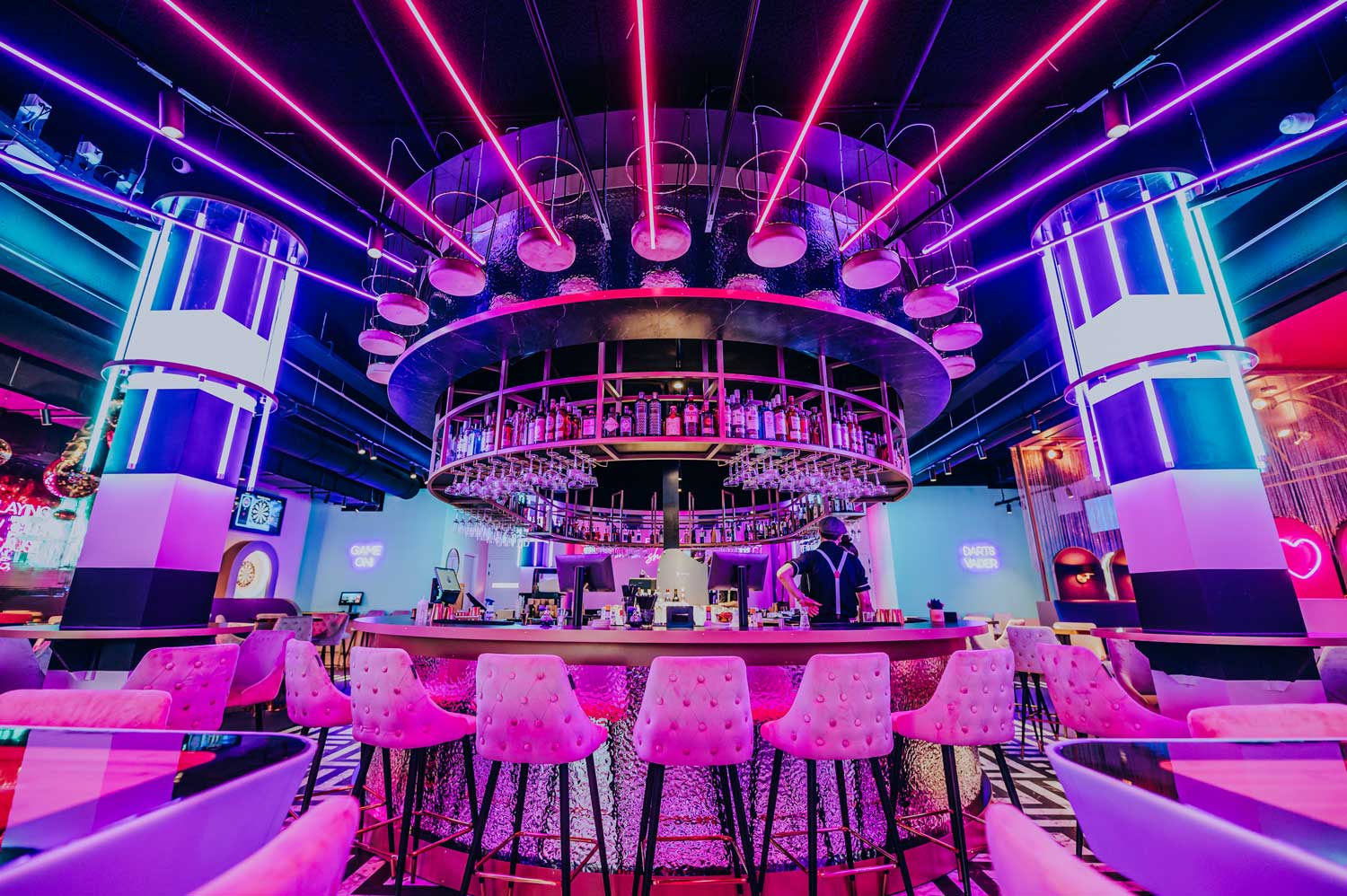 Colorful lights from Vivalyte illuminate The All Out Amsterdam’s bar area, offering an enthralling visual experience.